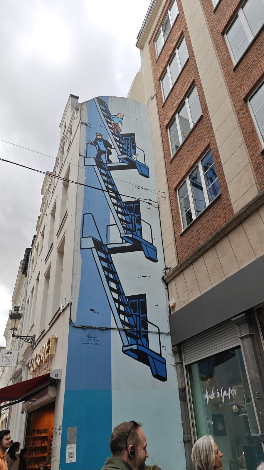Blue comic mural on a city building